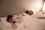 睡眠時無呼吸症候群の夫のいびきに耳を塞ぐ妻